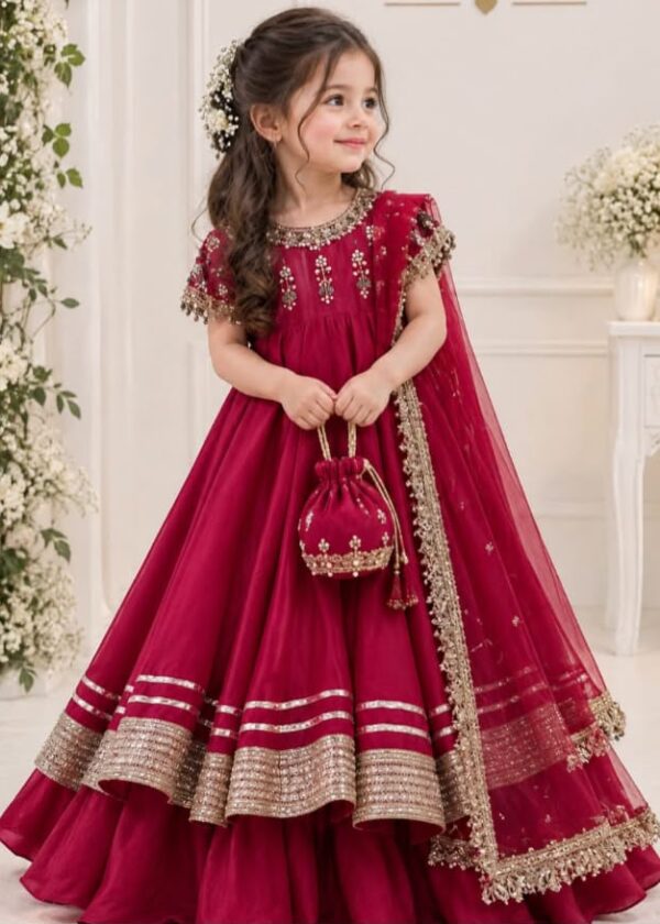 Shop kids festive wear in Dubai: a magenta Russian silk frock set with dabka handwork, silver lace, and a net dupatta. Perfect for weddings and Eid.