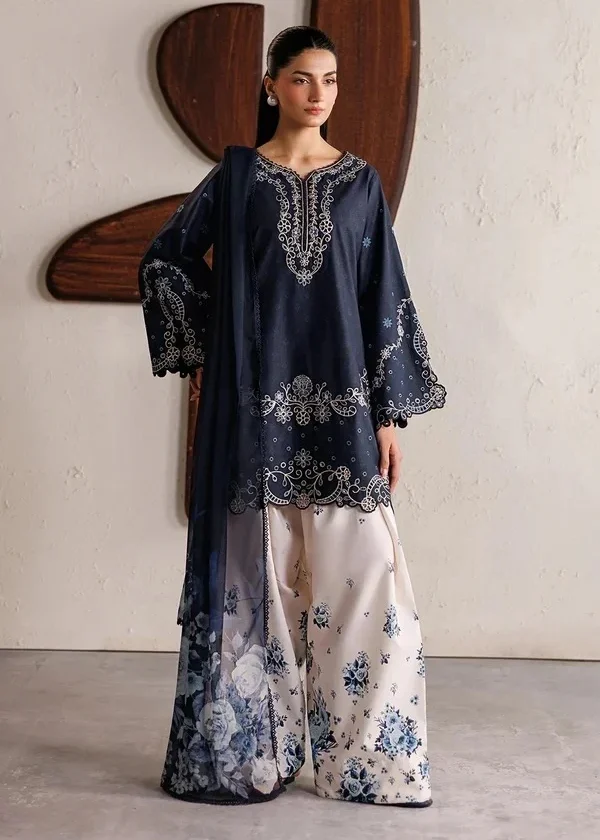 Woman wearing a navy blue embroidered Pakistani 3 piece suit with scalloped hem, floral printed trousers and dupatta