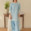 Woman wearing a sky blue embroidered Pakistani 3 piece suit with white embroidered dupatta and cuffed trousers