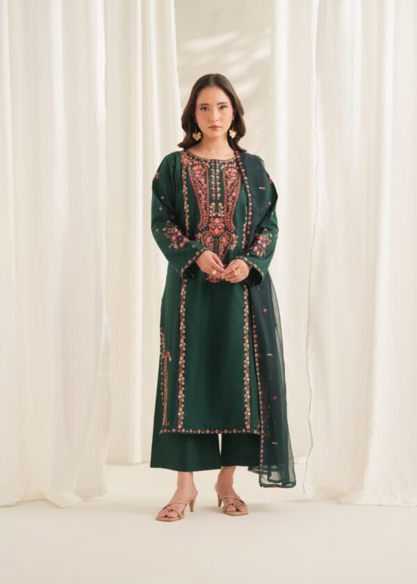Woman wearing an emerald green embroidered Pakistani 3 piece suit with floral neckline, embroidered borders and organza dupatta